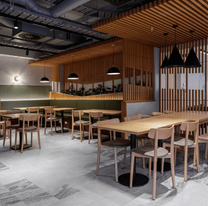 An interior view of a modern restaurant or cafe featuring a warm, contemporary design.